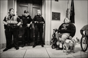 ADAPTer in motorized scooter and Capitol police officers outside Kevin McCarthy’s office.